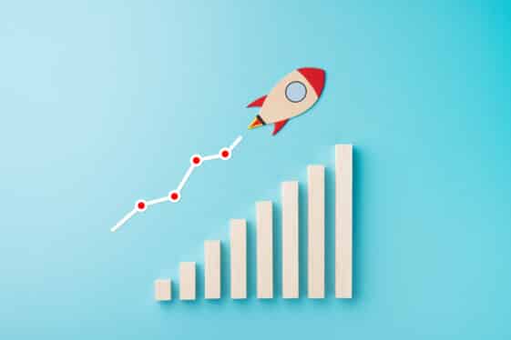 Rocket and chart on blue background business financial start up